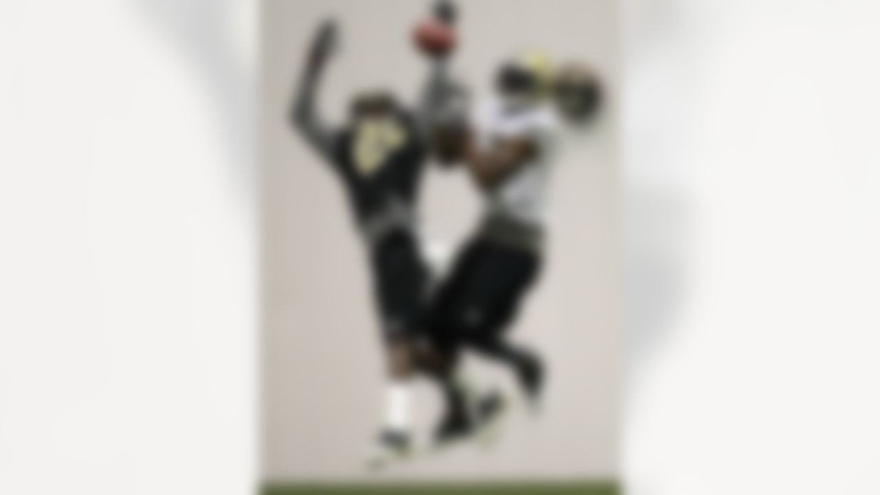 New Orleans Saints cornerback A.J. Davis (20) breaks up a pass intended for wide receiver Marques Colston during training camp at their indoor NFL football training facility in Metairie, La., Friday, July 27, 2012. (AP Photo/Gerald Herbert)