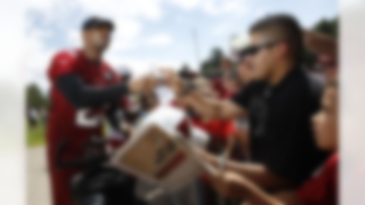 Arizona Cardinals' Kerry Rhodes signs autographs for fans at NFL football training camp at Northern Arizona University on Thursday, July 26, 2012, in Flagstaff, Ariz. (AP Photo/Ross D. Franklin)