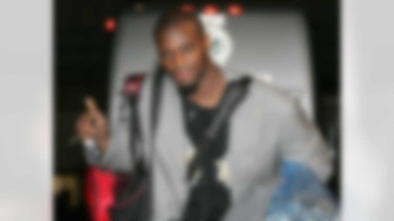 New York Giants' wide receiver Plaxico Burress gestures number one after getting of a team bus at Giants Stadium Stadium in East Rutherford, N.J. Monday, Feb. 4, 2008. The Giants returned home from Arizona after a 17-14 victory over the New England Patriots in Super Bowl XLII. (AP Photo/Rich Schultz)