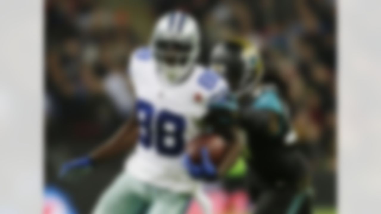 Dallas Cowboys wide receiver Dez Bryant (88) is defended by Jacksonville Jaguars strong safety Johnathan Cyprien (37) during the first half of an NFL football game at Wembley Stadium, London, Sunday, Nov. 9, 2014. (AP Photo/Matt Dunham)