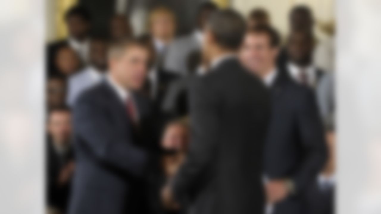 President Barack Obama, center, shakes hands with New Orleans Saints football coach Sean Payton, left, as Saints quarterback Drew Brees, right, looks on, during an event honoring the 2009 Super Bowl Champion New Orleans Saints NFL football team, Monday, Aug. 9, 2010, in the East Room of the White House in Washington. (AP Photo/Susan Walsh)