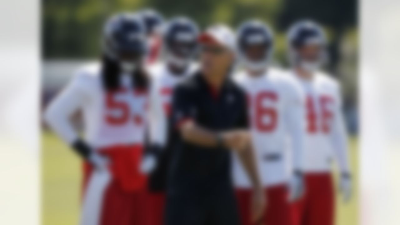 Atlanta Falcons defensive coordinator Mike Nolan works with players during NFL football training camp in Flowery Branch, Ga., Friday, July 27, 2012. (AP Photo/John Bazemore)