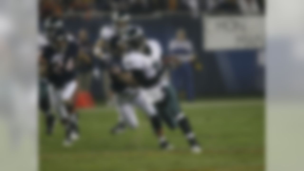 Philadelphia Eagles quarterback Michael Vick (7) is chased by Chicago Bears defenders on a long run in the first quarter of an NFL football game in Chicago, Sunday, Nov. 22, 2009. (AP Photo/Charles Rex Arbogast)