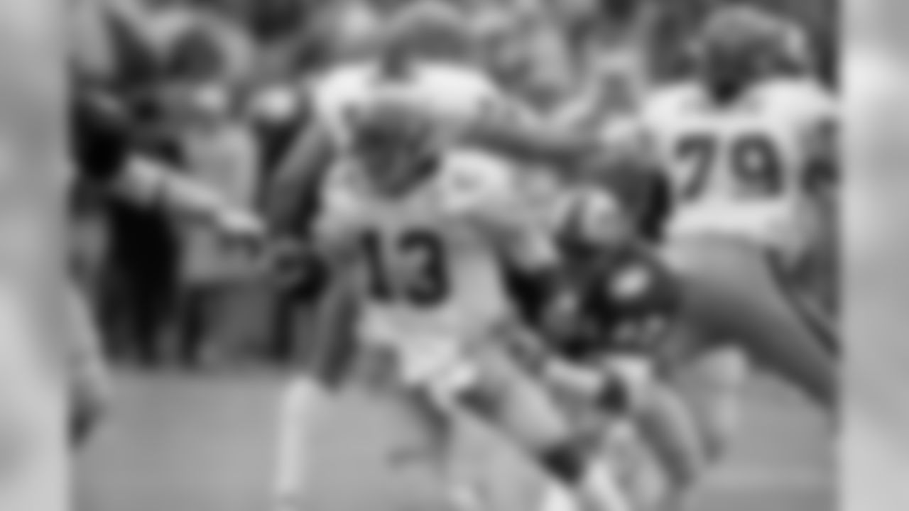 University of Pittsburgh quarterback Dan Marino (13) makes his move to elude the tackle attempt by Southern Methodist University defensive end Russell Washington, right, during first quarter action in the Cotton Bowl, Jan. 1, 1983 in Dallas. Marino gained two yards on the scramble. (AP Photo/Bill Haber)