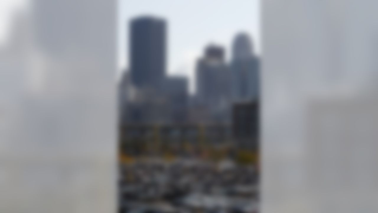 The city skyline rises above the fans gathered to tailgate in the parking lots surrounding Heinz Filed before the start of the NFLfootball game between the Pittsburgh Steelers and Cleveland Browns in Pittsburgh, Sunday, Oct. 18, 2009. (AP Photo/Keith Srakocic)