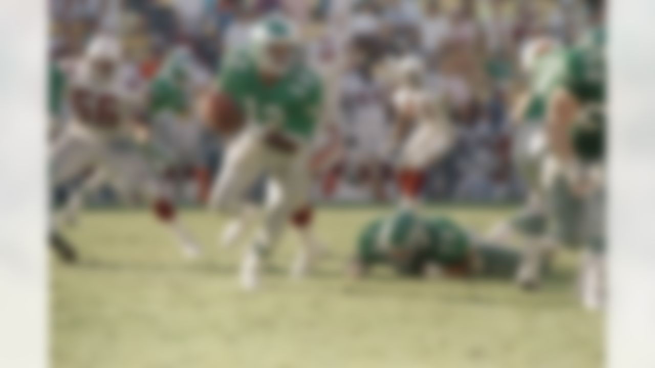 Philadelphia Eagles quarterback Randall Cunningham scrambles for a first down late in the fourth quarter in Tempe, Arizona on Sunday, Oct. 15, 1989. The Eagles defeated Phoenix 17-5. (AP Photo/Rob Schumacher)