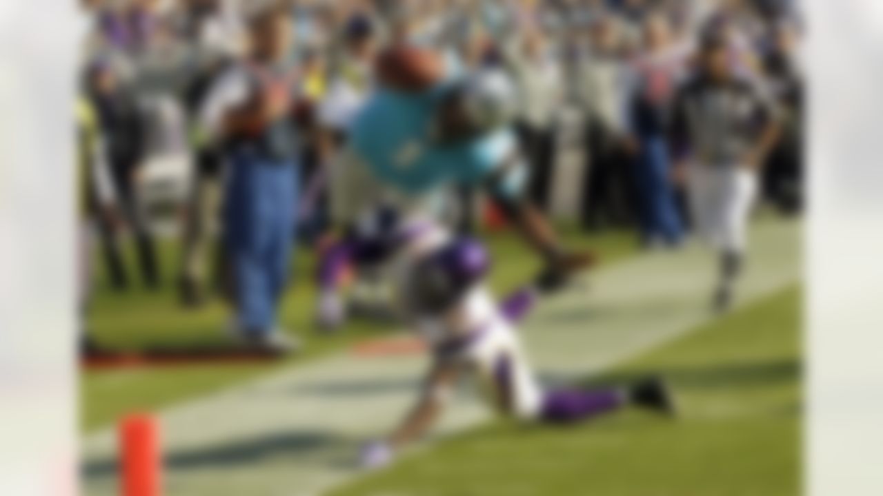 Carolina Panthers' Cam Newton (1) is upended by Minnesota Vikings' Husain Abdullah (39) during the fourth quarter of the Vikings' 24-21 win in an NFL football game in Charlotte, N.C., Sunday, Oct. 30, 2011. (AP Photo/Chuck Burton)