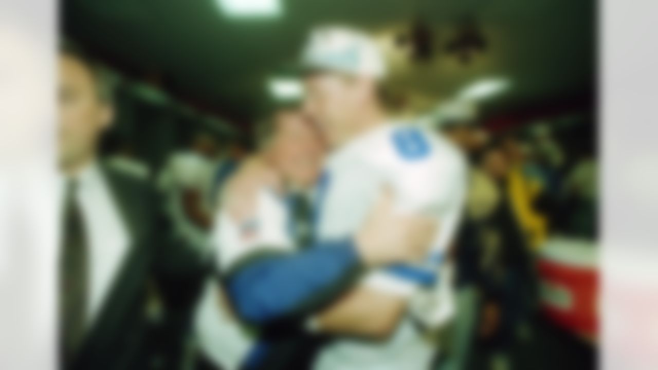 Dallas Cowboys' head coach Jimmy Johnson hugs quarterback Troy Aikman in their locker room after defeating the Buffalo Bills 30-13 in Super Bowl XXVIII at the Georgia Dome, Jan. 30, 1994. The Cowboys handed the Bills their fourth straight Super Bowl defeat. (AP Photo/Charles Krupa)