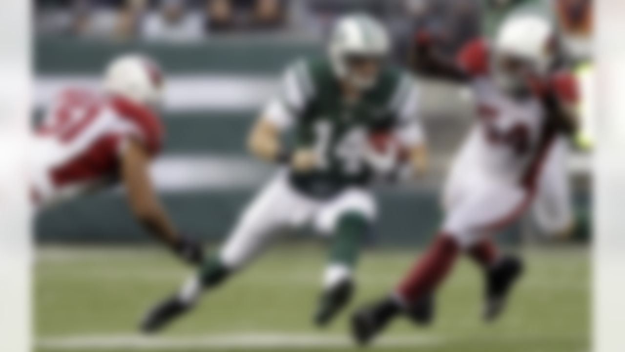 New York Jets quarterback Greg McElroy (14) runs with the ball as Arizona Cardinals inside linebacker Paris Lenon (51) and outside linebacker Quentin Groves (54) defend during the second half of an NFL football game on Sunday, Dec. 2, 2012, in East Rutherford, N.J. The Jets won 7-6. (AP Photo/Kathy Willens)