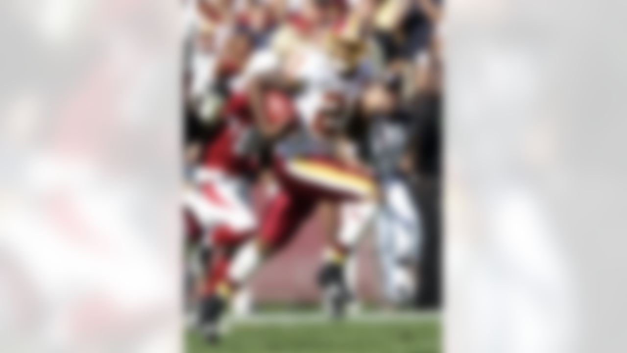 Washington Redskins safety Sean Taylor is chased by the Arizona Cardinals after Taylor made a first-quarter interception during an NFL football game in Landover, Md., on Oct. 21, 2007 (AP Photo/Evan Vucci)