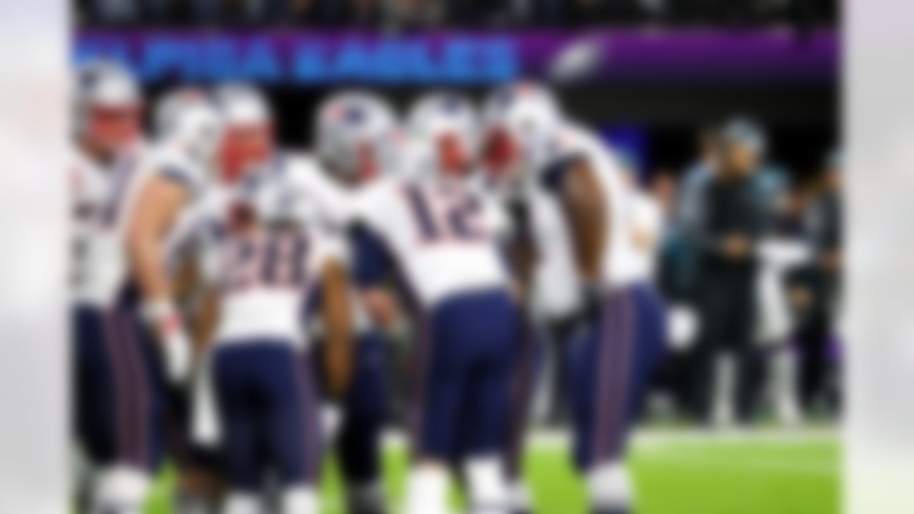 New England Patriots quarterback Tom Brady (12) huddles with teammates.