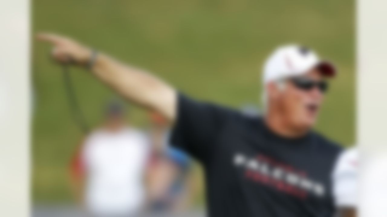 Atlanta Falcons head coach Mike Smith directs his players to the next drill during NFL football training camp in Flowery Branch, Ga., Tuesday, July 31, 2012. (AP Photo/John Bazemore)