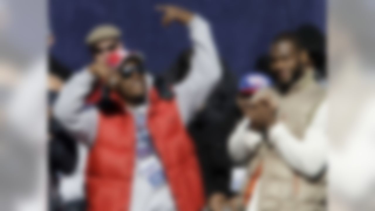 New York Giants defensive end Jason Pierre Paul, right, applauds as teammate Deion Grant does a dance during a ceremony for the NFL football Super Bowl XLVI champions at City Hall in New York, Tuesday, Feb. 7, 2012. (AP Photo/Kathy Willens)