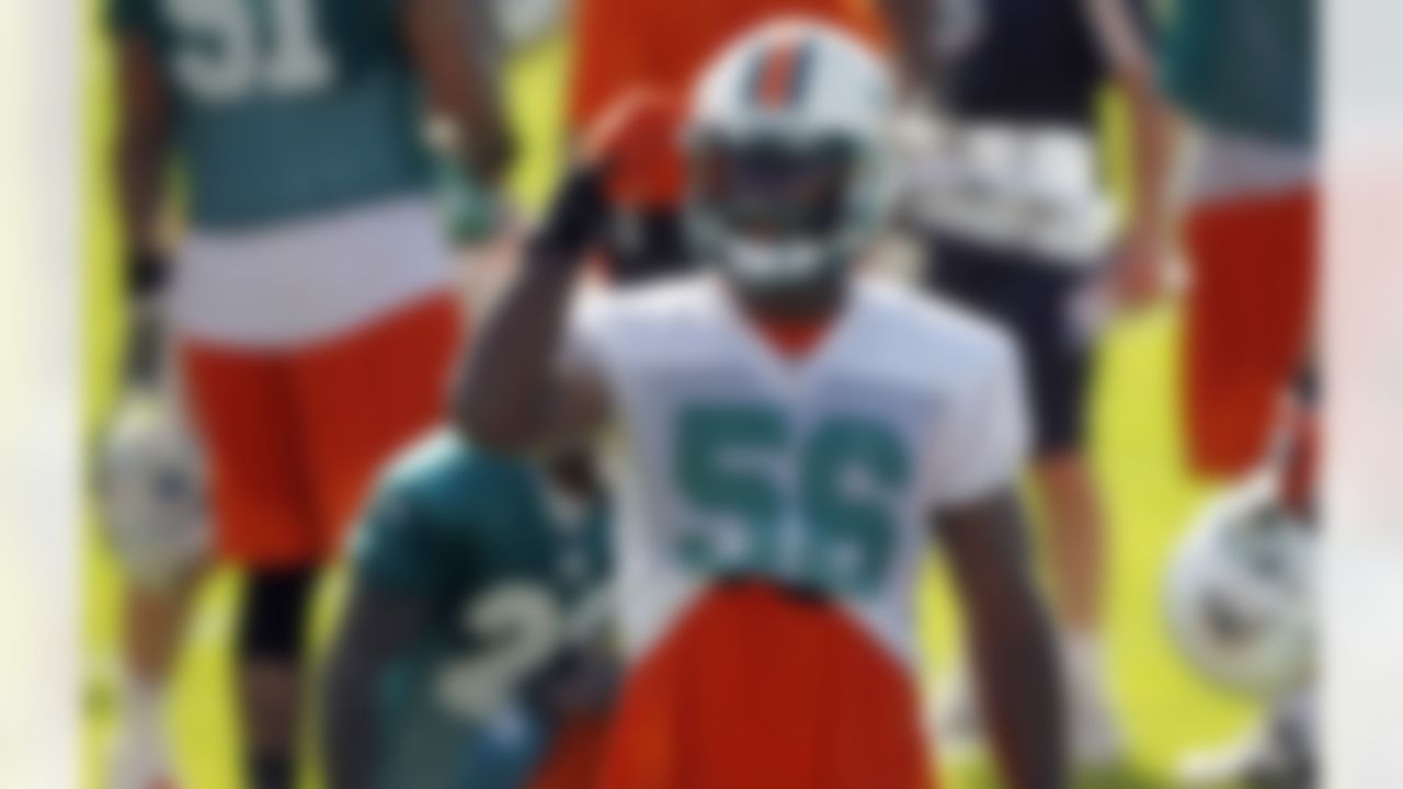 Miami Dolphins' Kevin Burnett adjusts his helmet during NFL football training practices in Davie, Fla., Friday, July 27, 2012. (AP Photo/Alan Diaz)