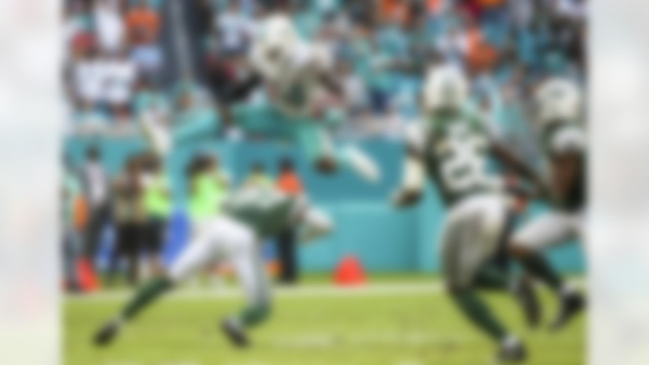Miami Dolphins wide receiver Jarvis Landry (14) hurdles over New York Jets cornerback Darryl Roberts (27) during a game Sunday, Oct. 22, 2017, in Miami Gardens, Fla.