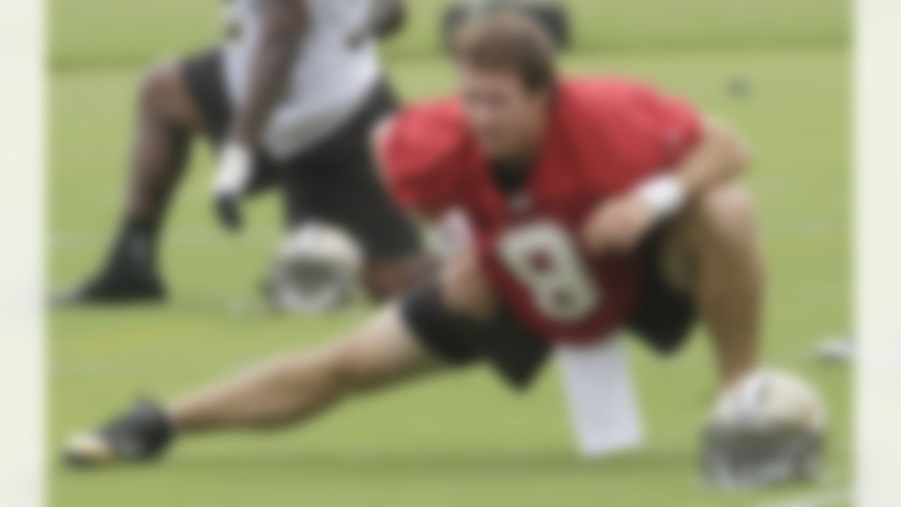 New Orleans Saints quarterback Drew Brees (9) stretches at the at the club's NFL football training facility in Metairie, Friday, June 4, 2010. (AP Photo/Bill Haber)
