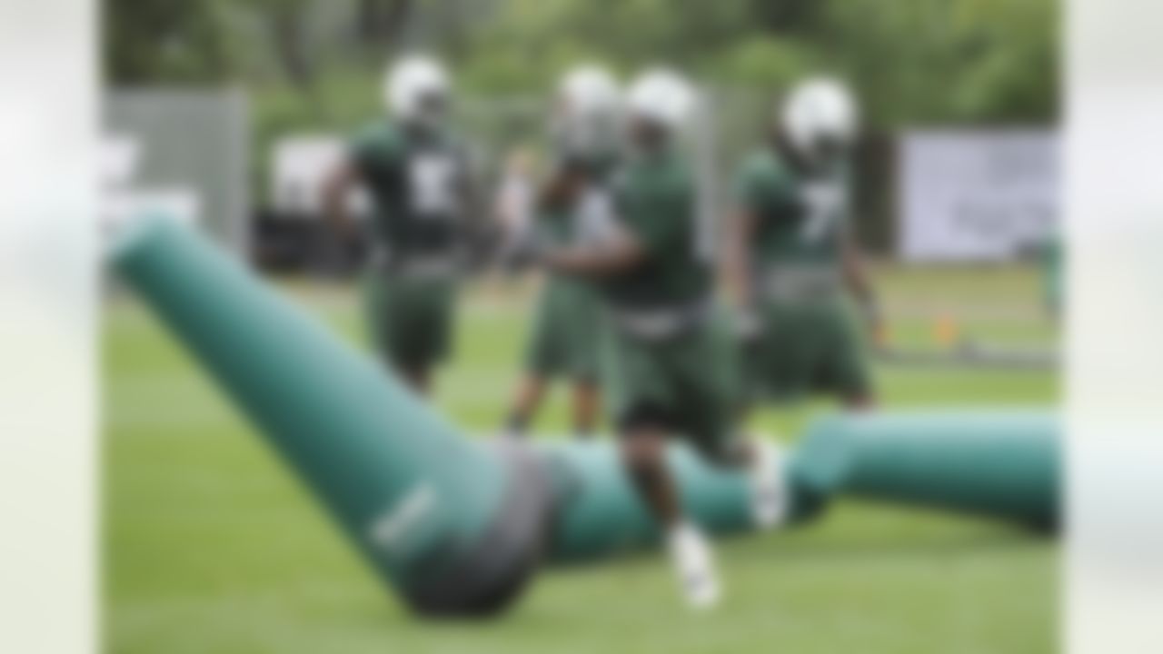 New York Jets defensive tackle Marcus Dixon runs a drill on opening day of their NFL football training camp Friday, July 27, 2012, in Cortland, N.Y. (AP Photo/Bill Kostroun)