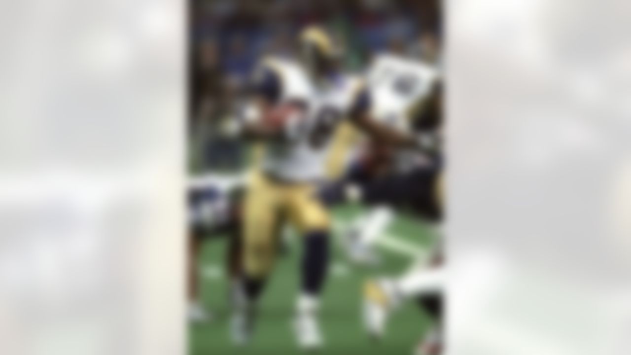 St. Louis Rams running back Marshall Faulk (28) carries the ball during Super Bowl XXXVI, a 20-17 New England Patriots victory over the St. Louis Rams on February 3, 2002, at the Louisiana Superdome in New Orleans, Louisiana. (National Football League)