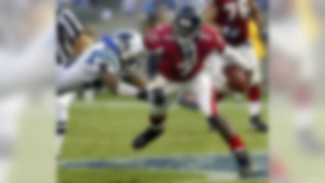 Atlanta Falcons quarterback Michael Vick (7) runs past Carolina Panthers' Brandon Short (53) during the fourth quarter of the Falcons' 27-10 win in Charlotte, N.C., Sunday, Oct. 3, 2004. (AP Photo/Chuck Burton)