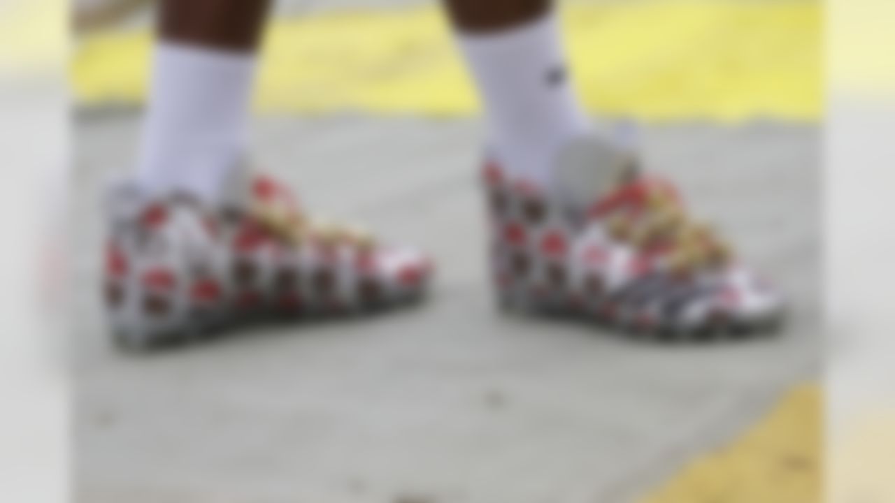 Denver Broncos outside linebacker Von Miller (58) walks across the field wearing Christmas-themed cleats before an NFL football game against the Washington Redskins in Landover, Md., Sunday, Dec 24, 2017.