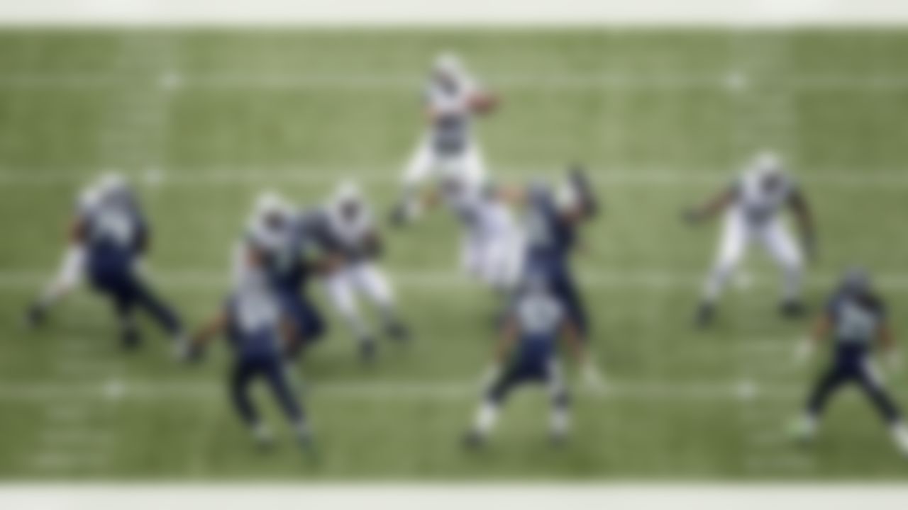 New York Jets quarterback Tim Tebow, top, passes against the Seattle Seahawks during the first half of an NFL football game, Sunday, Nov. 11, 2012, in Seattle. (AP Photo/Stephen Brashear)