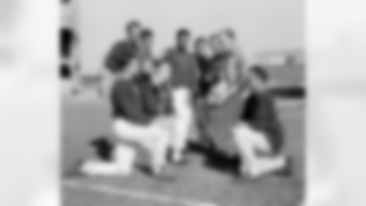 Defensive backfield coach Tom Landry holds a ball as New York Giant defense men huddle on Nov. 6, 1958 during workout at Yankee stadium in New York City. They will be called on Nov. 9 to stop the passing and running attack of the undefeated baltimore colts. From left to right are; kneeling, linebacker Harland Svare, middle guard Sam Huff and back Cliff Livingston. Standing, backs Carl Karilivacz, Jim Patton, Em Tonnell, Linebacker Bill Svoboda, back Lindon Crow and landry. (AP Photo/John Lindsay)