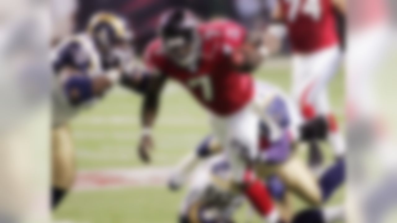 Atlanta Falcons quarterback Michael Vick (7) is tied up following a first half run by St. Louis Rams tackle Ryan Pickett (79), safety Adam Archuleta (31) and linebacker Robert Thomas (55) during the NFC Divisional Playoffs at the Georgia Dome in Atlanta, Saturday, Jan. 15, 2005. (AP Photo/John Amis)