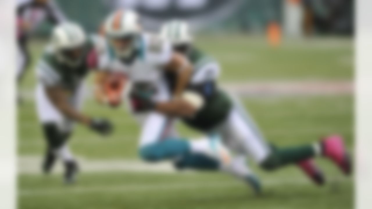 Miami Dolphins wide receiver Brian Hartline (82) is tackled by New York Jets strong safety Yeremiah Bell (37) during the first half of an NFL football game Sunday, Oct. 28, 2012 in East Rutherford, N.J. (AP Photo/Bill Kostroun)