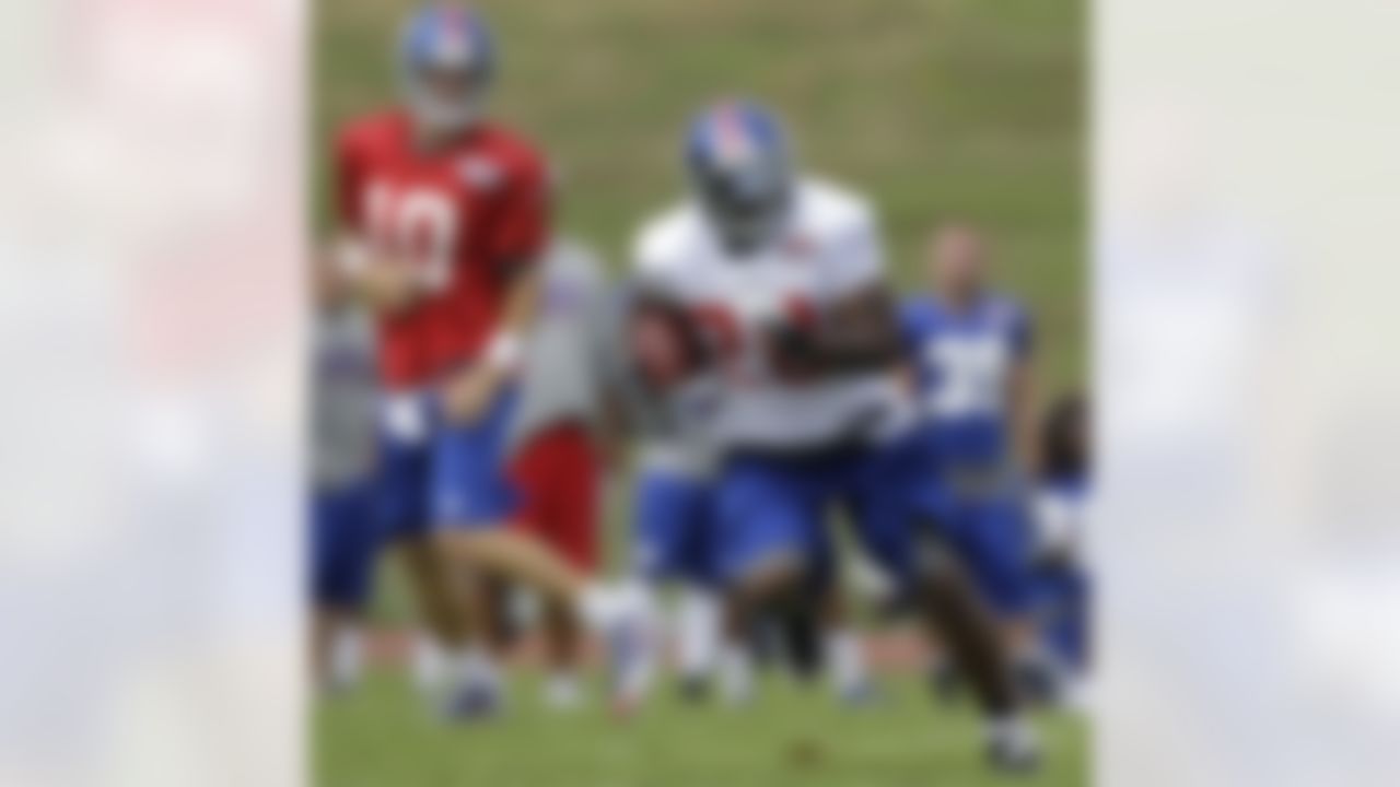 New York Giants quarterback Eli Manning (10) watches, after handing off to Giants running back Ahmad Bradshaw (44) during a practice at the New York Giants football training camp in Albany, N.Y., Friday, July 27, 2012. Despite winning the Super Bowl, the Giants were the NFL's worst team rushing. Bradshaw, the Giants No. 1 running back, said, "That's devastating for us." (AP Photo/Kathy Willens)