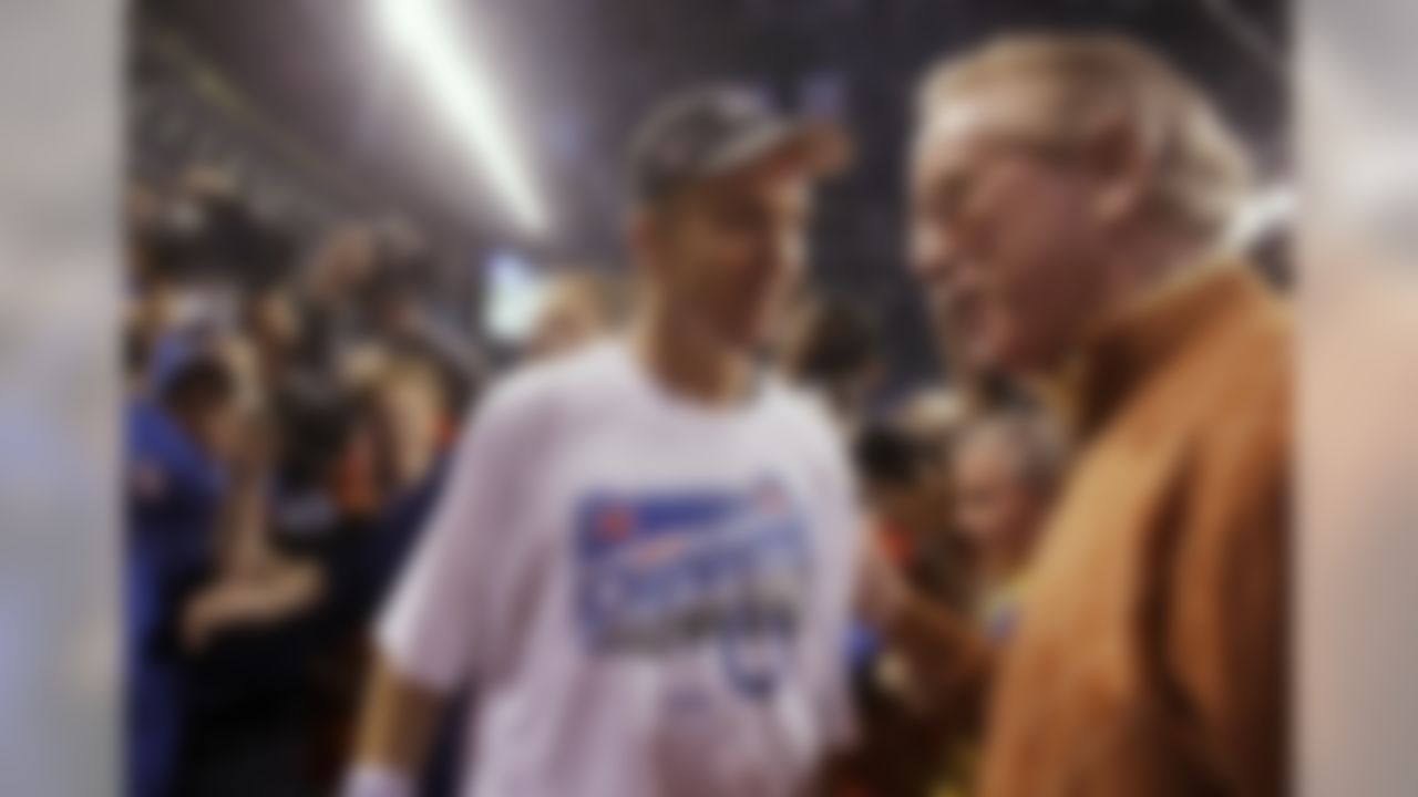 Indianapolis Colts quarterback Peyton Manning (18) talks with his father, former NFL quarterback, Archie Manning, after the Colts' 30-17 win over the New York Jets in the AFC Championship NFL football game Sunday, Jan 24, 2010, in Indianapolis. The Colts advance to the Super Bowl. (AP Photo/Rob Carr)