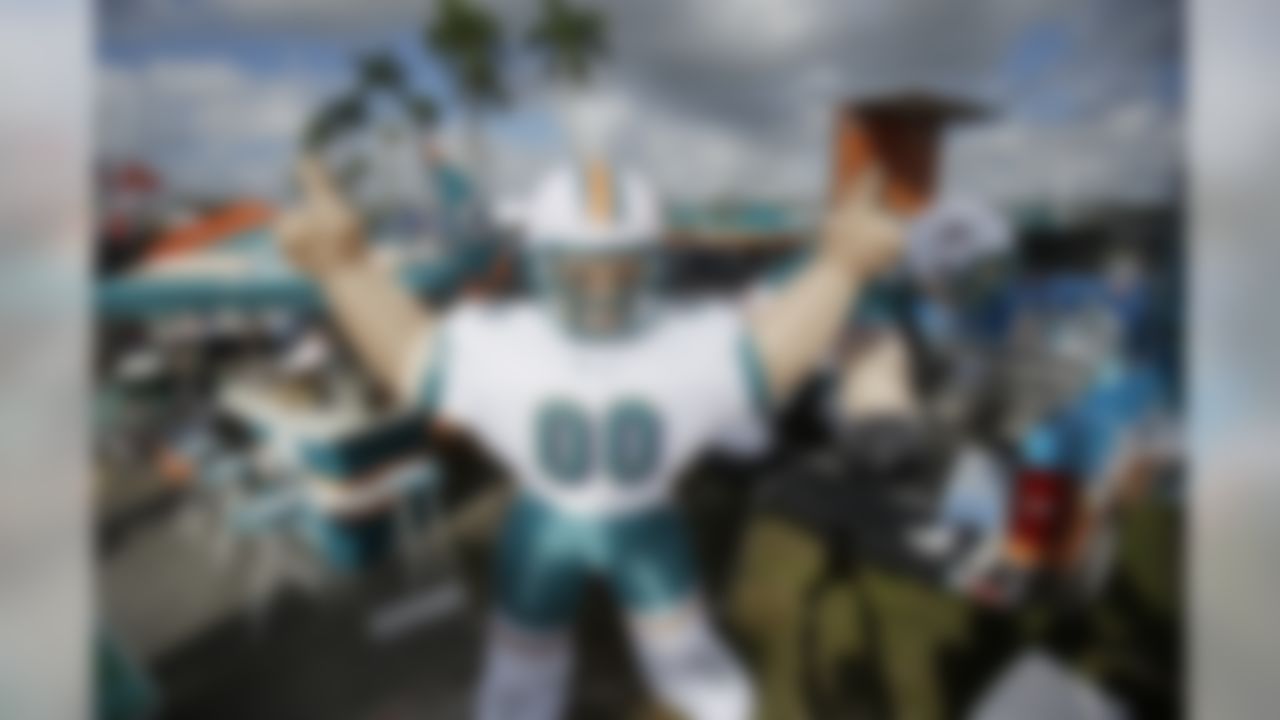 Miami Dolphins inflatable decorations are displayed by a fan before an NFL football game against the New York Jets, Sunday, Dec. 28, 2014, in Miami Gardens, Fla. (AP Photo/Wilfredo Lee)