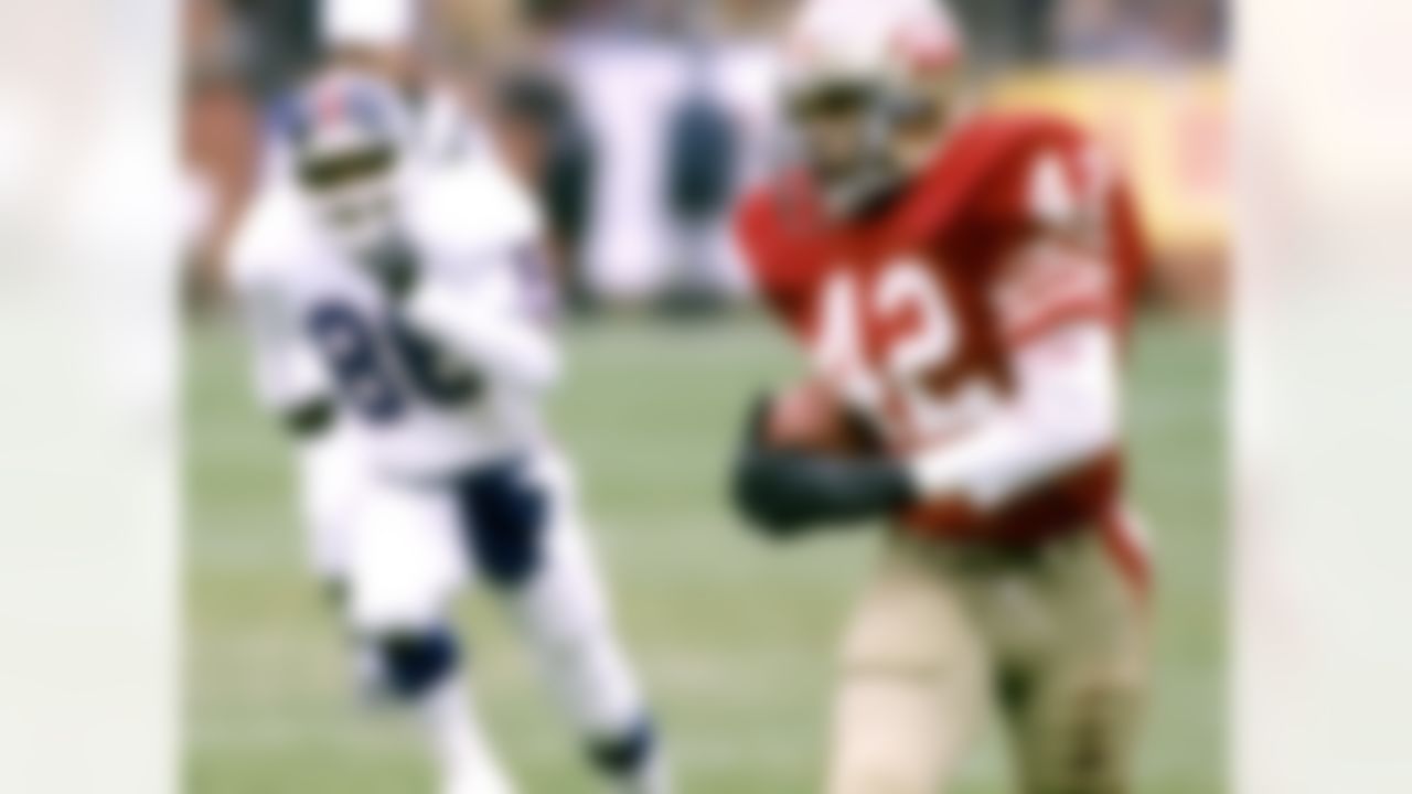 Hall of Fame cornerback Ronnie Lott (42) of the San Francisco 49ers runs with the football after intercepting a pass during the 49ers 21-10 victory over the New York Giants in the 1984 NFC Divisional Playoff Game on December 29, 1984 at Candlestick Park in San Francisco, California. (National Football League)
