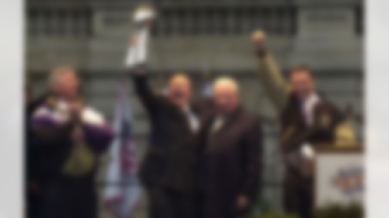 Maryland Governor Parris Glendening, left, Baltimore Ravens president David Modell, holding the Vince Lombardi trophy, Ravens owner Art Modell, and Baltimore Mayor Martin O'Malley, right, react as they show the crowd the trophy during the Ravens parade Tuesday, Jan. 30, 2001 inn Baltimore. The Ravens beat the New York Giants 34-7 in Sunday's Super Bowl. (AP Photo/Chris Gardner)