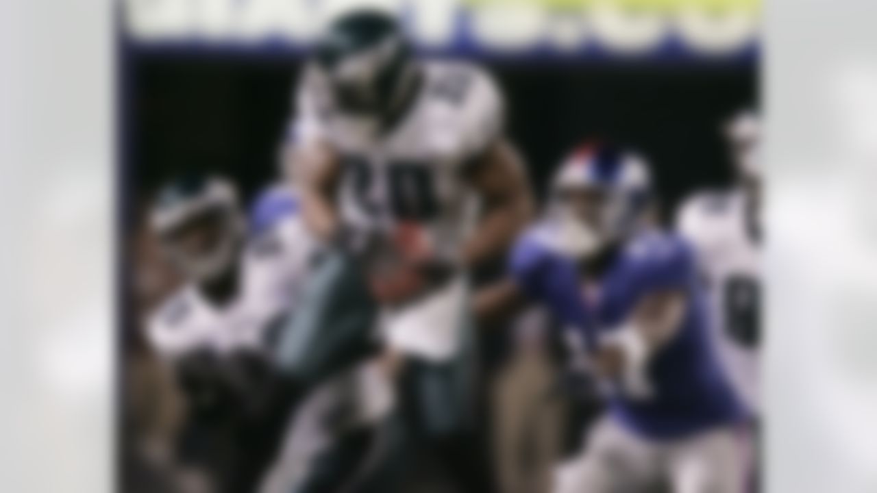 * FILE * Philadelphia Eagles' Brian Dawkins (20) comes down with a tipped pass in front of teammate Lito Sheppard, left, and New York Giants' Plaxico Burress for an interception in an NFL football game Dec. 17, 2006, in East Rutherford, N.J. Dawkins, sidelined since Week 2 with a neck stinger, expects to play Sunday, Nov. 4, for the Eagles against the Cowboys. (AP Photo/Julie Jacobson)