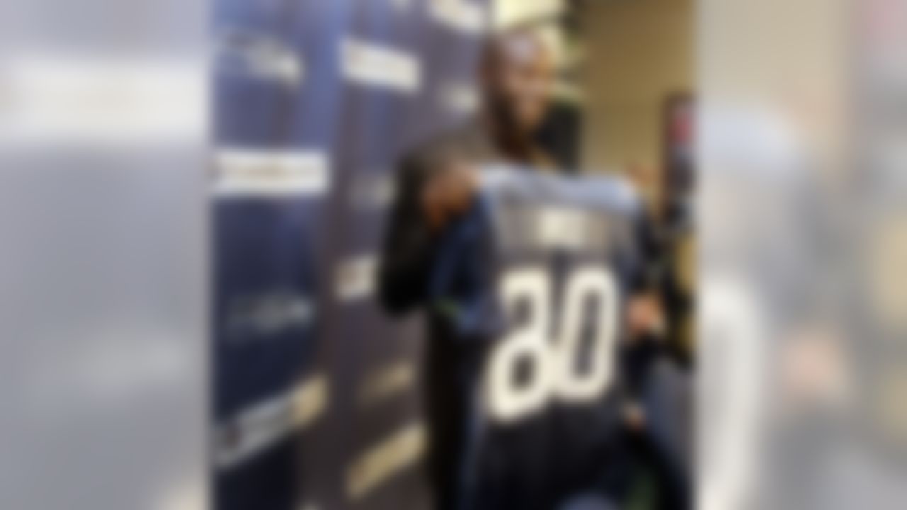 New Seattle Seahawks wide receiver Jerry Rice shows off his new jersey Tuesday, Oct. 19, 2004 at Seahawks headquarters in Kirkland, Wash. The Seahawks acquired Rice Tuesday from the Oakland Raiders and Rice said he asked permission from legendary Seahawks' wide receiver Steve Largent to wear Largent's number 80. (AP Photo/Ted S. Warren)