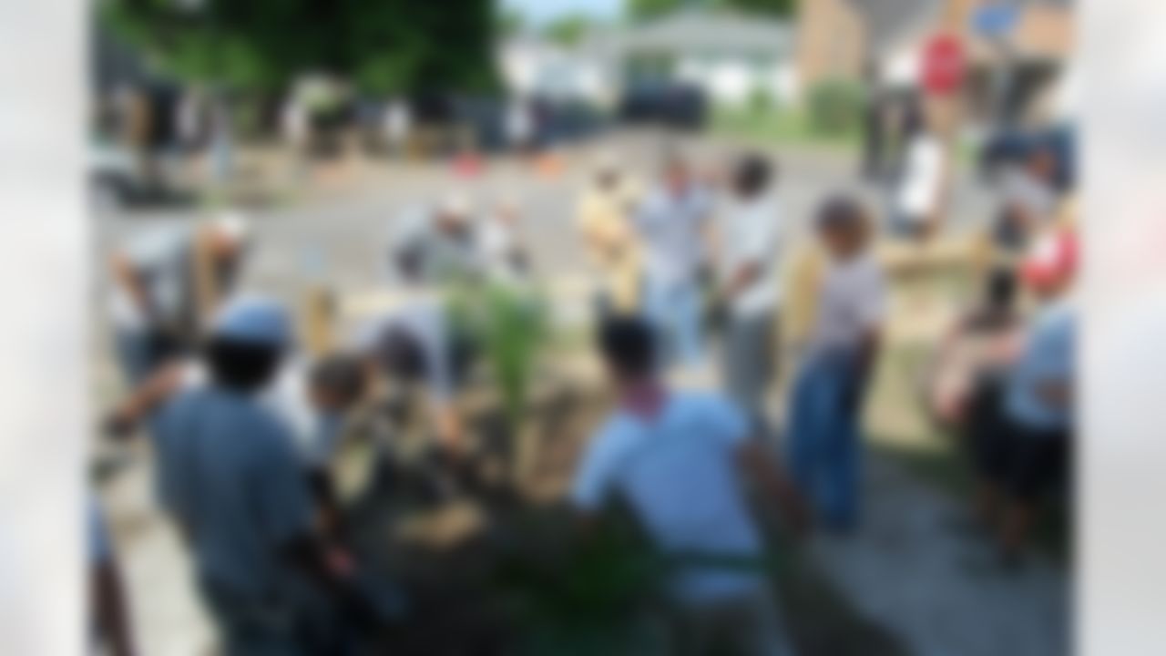 Members of the New Orleans Saints help to rebuild a home ravaged by Hurricane Katrina in New Orleans, Louisiana on June 10, 2008.