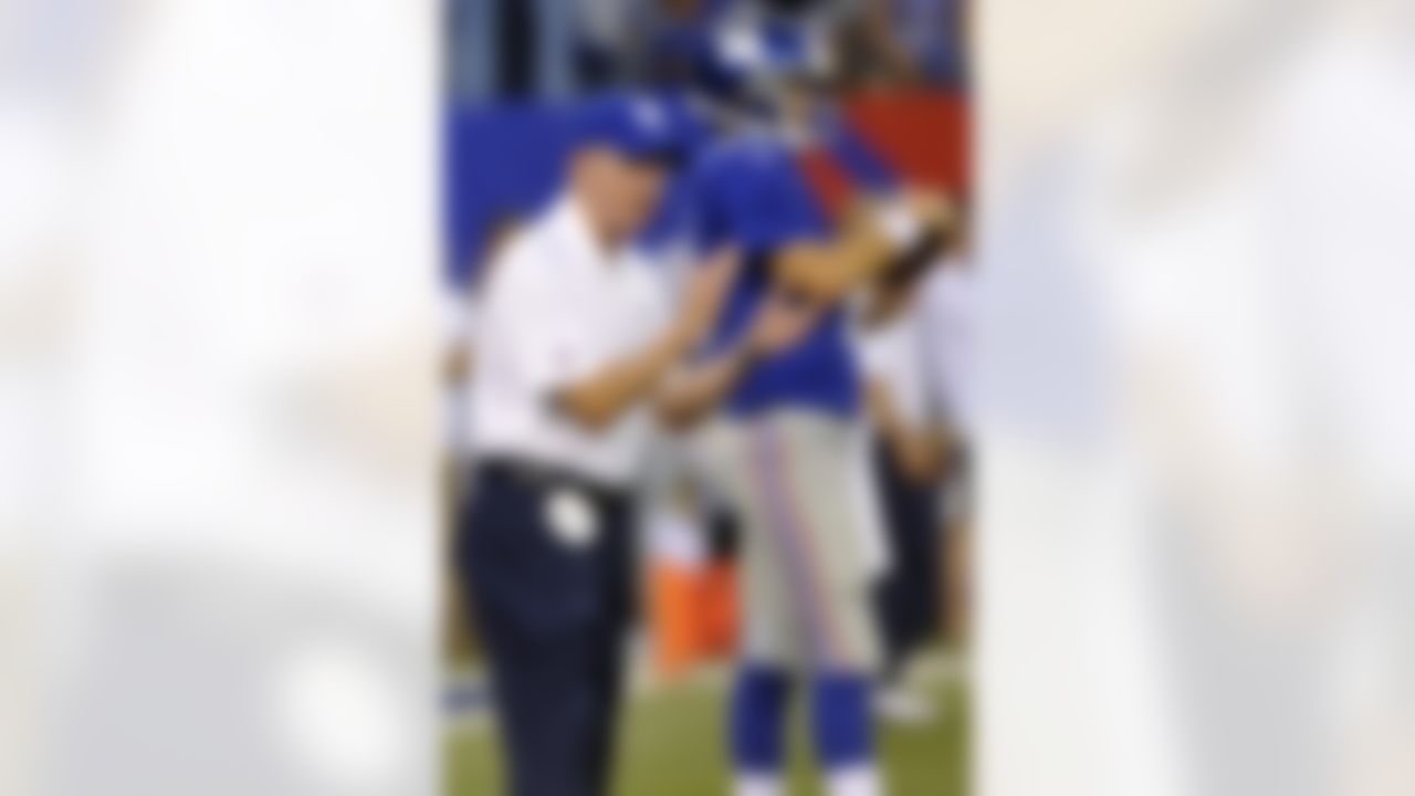 New York Giants head coach Tom Coughlin claps in front of quarterback Eli Manning as his team warms up before a preseason NFL football game against the Chicago Bears in East Rutherford, N.J. (AP Photo/Bill Kostroun)