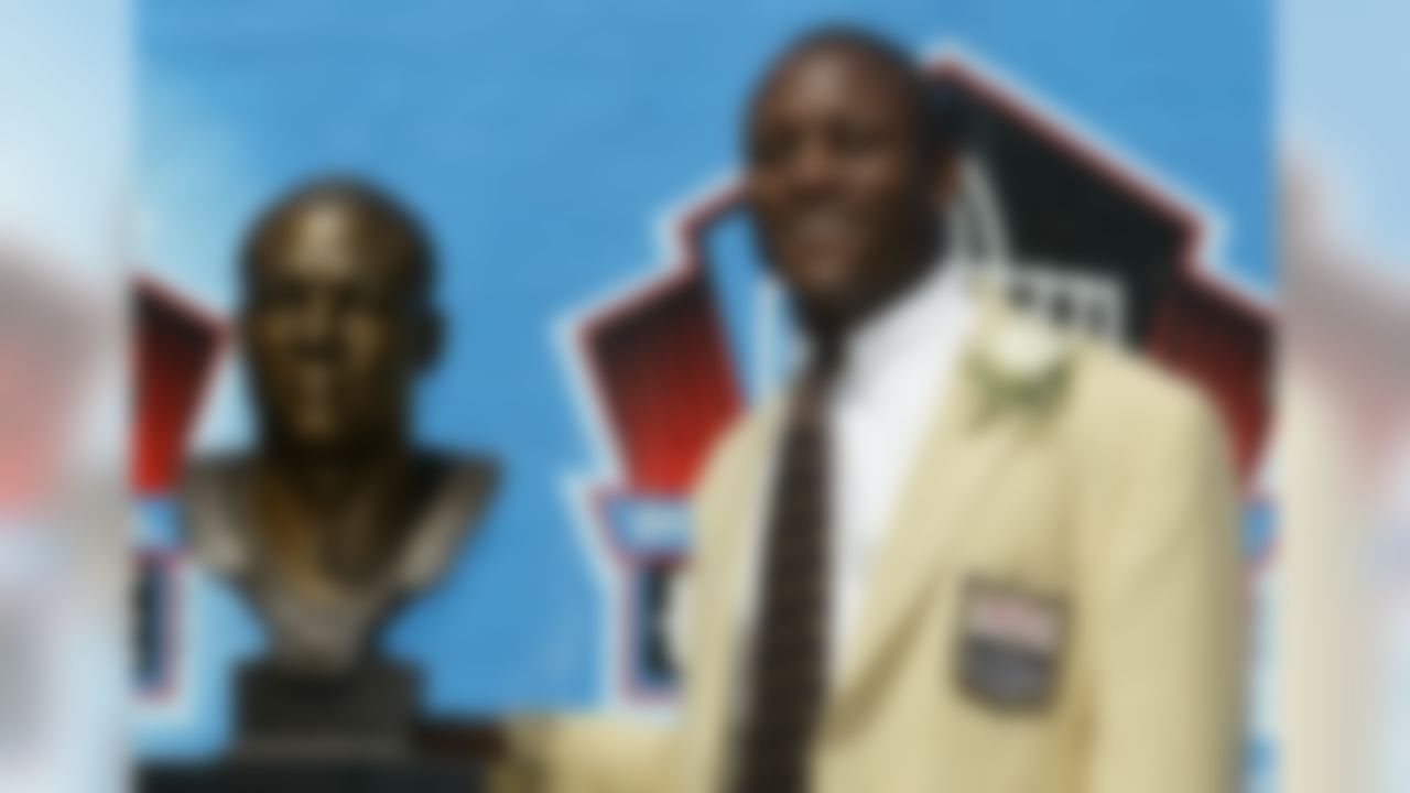 Barry Sanders poses with his bust after his induction into the Pro Football Hall of Fame, Sunday, Aug. 8, 2004, in Canton, Ohio. (AP Photo/Ron Schwane)