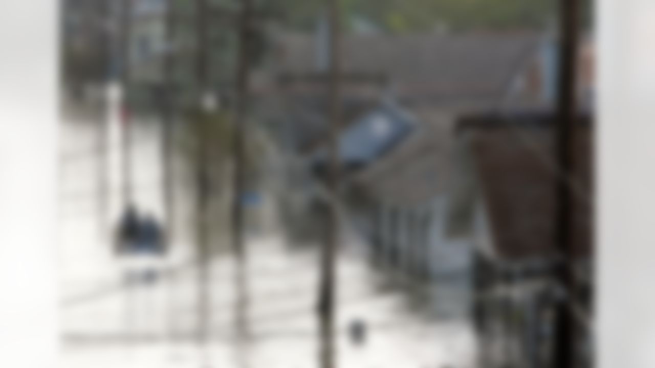 Rescue personnel search for victims as they traverse the Eighth Ward in the flooded city of New Orleans on Tuesday, Aug. 30, 2005. (AP Photo/Dave Martin)