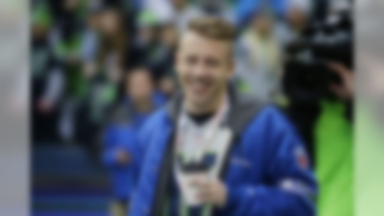 Rapper Macklemore watches teams warm up before the NFL football NFC Championship game between the Seattle Seahawks and the San Francisco 49ers, Sunday, Jan. 19, 2014, in Seattle. (AP Photo/Ted S. Warren)
