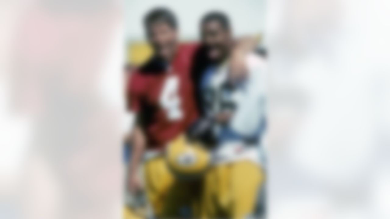 Green Bay Packers quarterback Brett Favre (4) and wide receiver Antonio Freeman (86) pose playfully at training camp in 1997. (AP Photo/Al Messerschmidt)