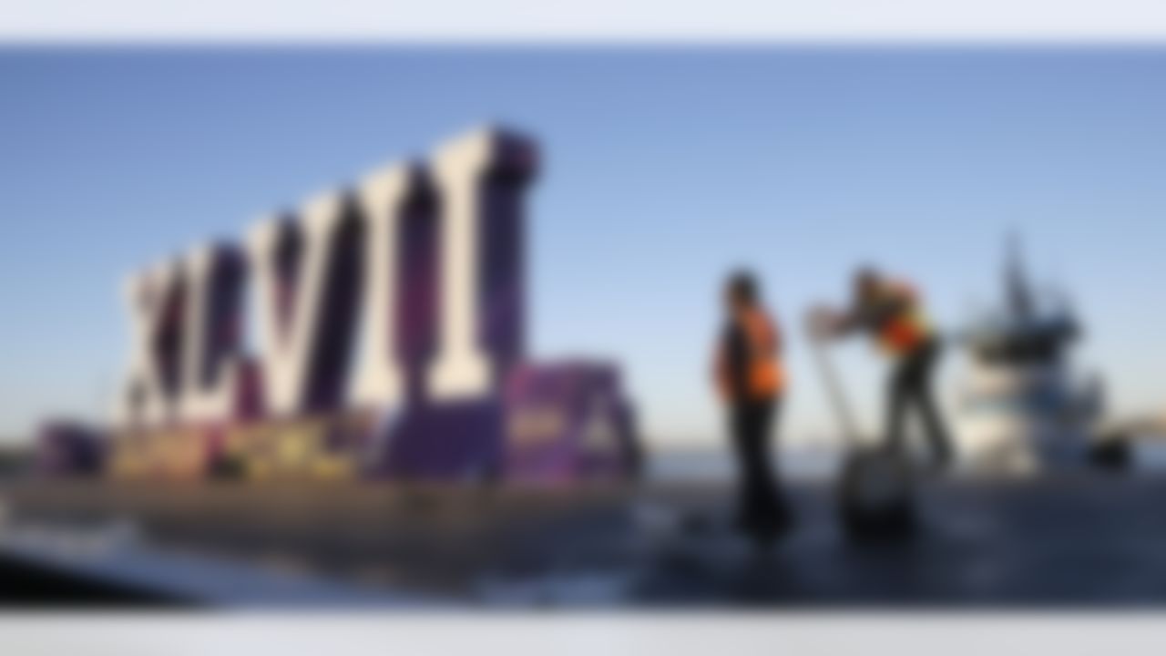 Workers tighten mooring ropes on a barge floating in the Mississippi River with a giant Super Bowl XLVII logo aboard as part of fan festivities, Friday, Feb. 1, 2013, in New Orleans. The Baltimore Ravens play the San Francisco 49ers in Super Bowl XLVII on Sunday. (AP Photo/Elaine Thompson)