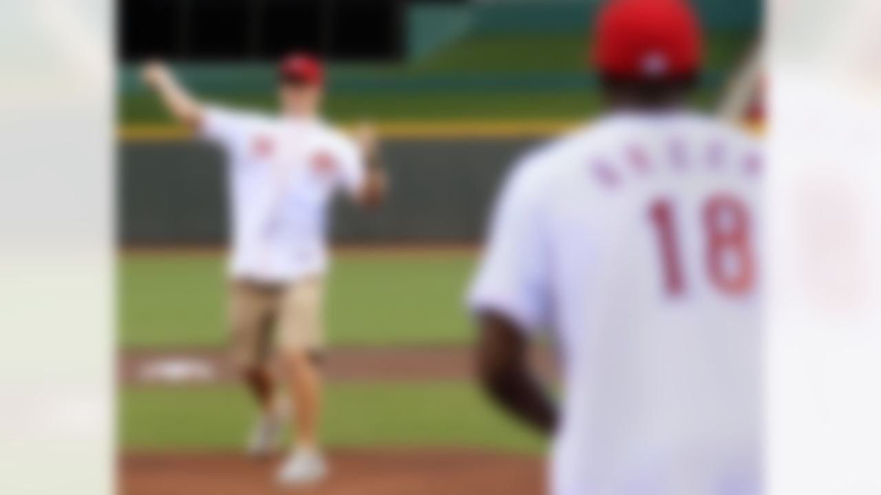 Cincinnati Bengals quarterback Andy Dalton (14) throws a ceremonial first pitch to wide receiver A.J. Green (18) prior to a baseball game between the Cincinnati Reds and the Philadelphia Phillies, Tuesday, Sept. 4, 2012, in Cincinnati. (AP Photo/Al Behrman)