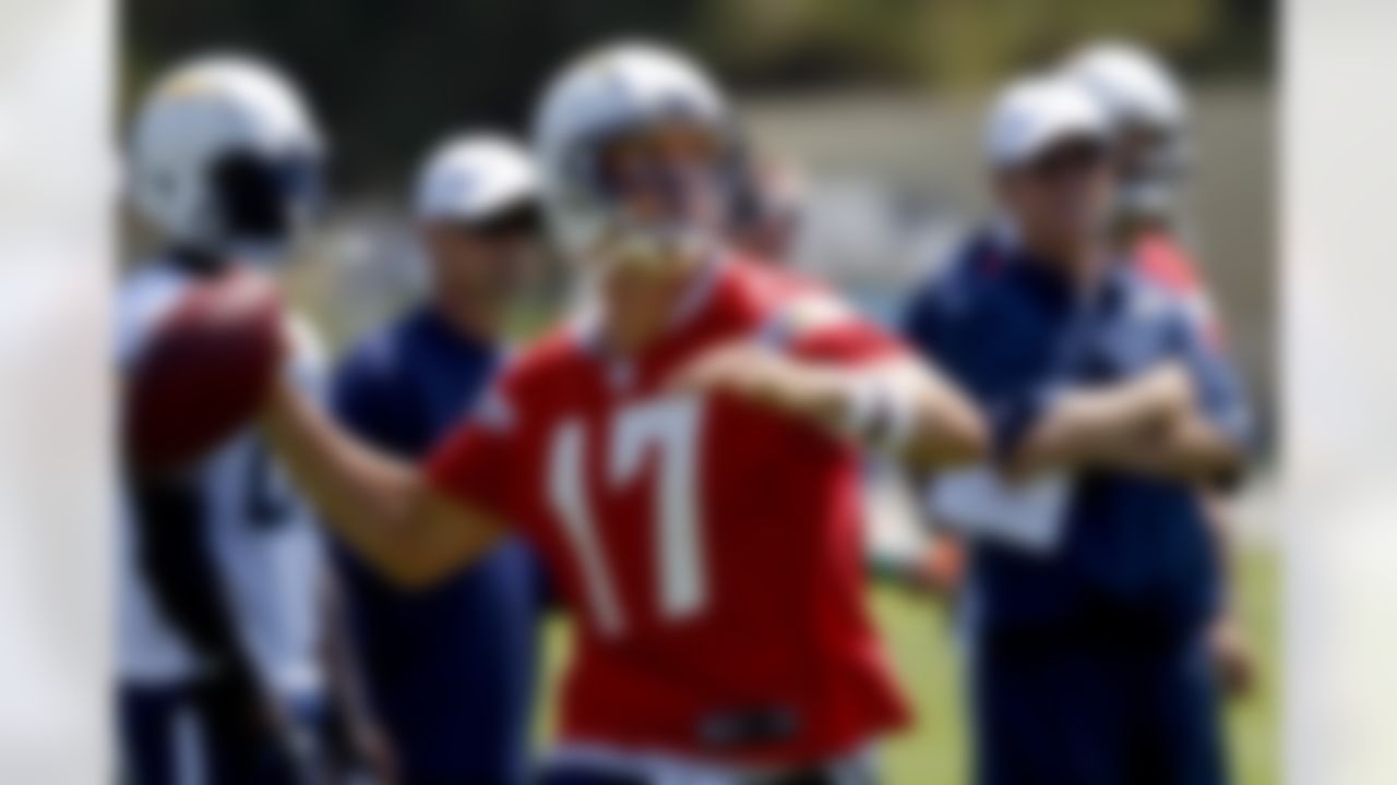 San Diego Chargers quarterback Philip Rivers aims a pass down field as coach Norv Turner, right, watches during practice at the Chargers' training camp Monday, July 23, 2012 in San Diego. (AP Photo/Lenny Ignelzi)