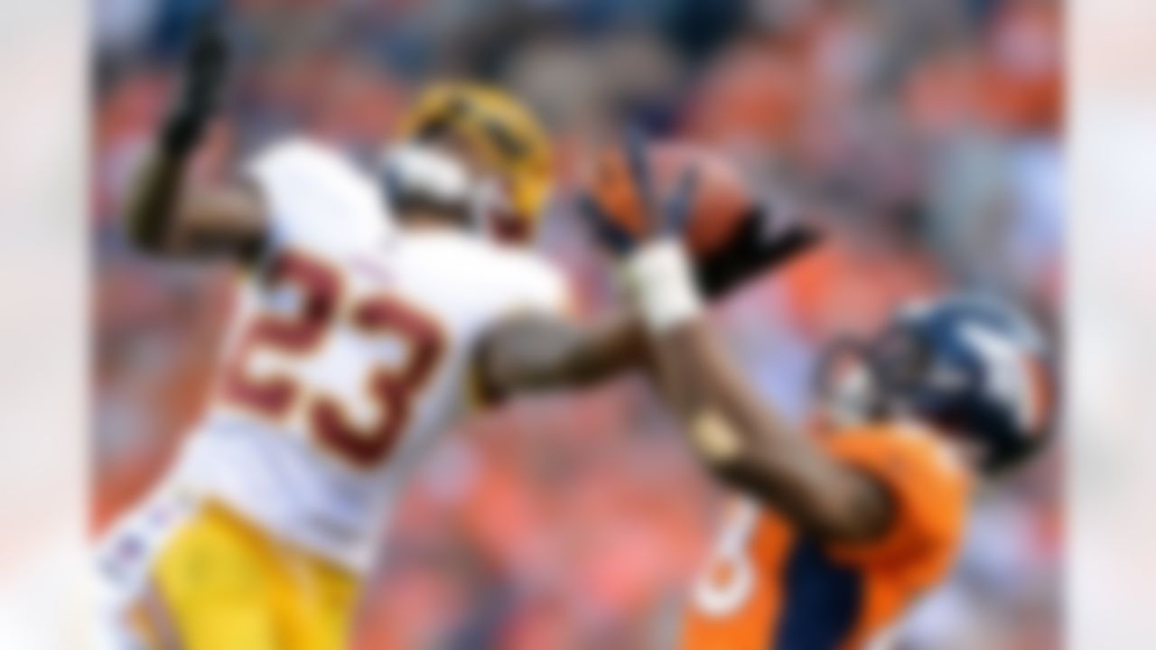 Washington Redskins defensive back DeAngelo Hall (23) intercepts a pass during an NFL football game that was intended for Denver Broncos wide receiver Demaryius Thomas (88) on Sunday, Oct. 27, 2013, in Denver.
