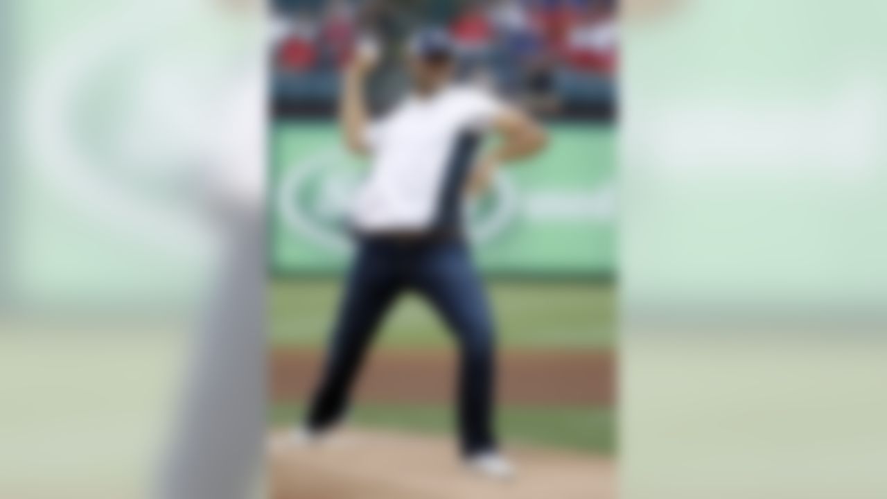 Dallas Cowboys quarterback Tony Romo delivers the ceremonial first pitch before a baseball game between the Seattle Mariners and the Texas Rangers, Wednesday, May 30, 2012, in Arlington, Texas. (AP Photo/Tony Gutierrez)