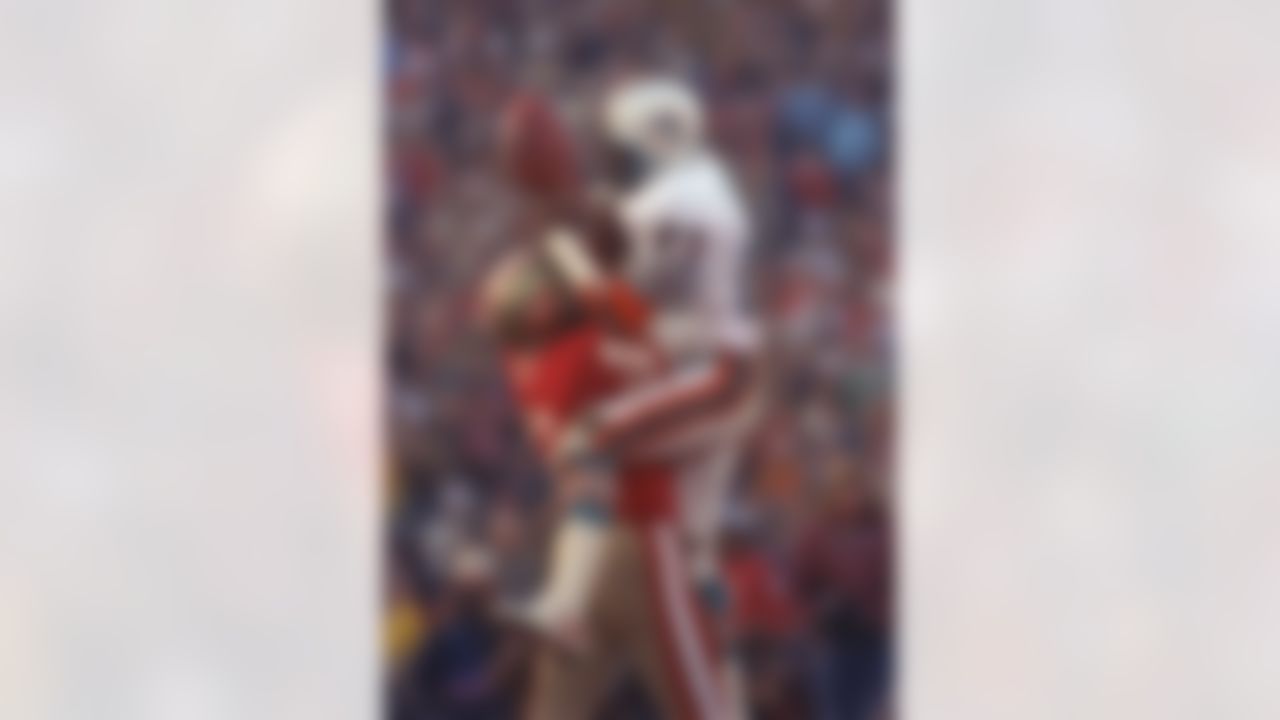 San Francisco 49ers cornerback Ronnie Lott (42) slams into Miami Dolphins receiver Mark Clayton (83) to break up pass during Super Bowl XIX at Stanford Stadium in Stanford, CA on January 20, 1985. (Associated Press)
