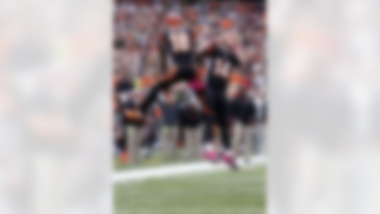 Cincinnati Bengals wide receiver A.J. Green (18) does a leaping hip bump with Bengals quarterback Andy Dalton (14) as he celebrates after catching a fourth quarter touchdown pass that cuts the Miami Dolphins lead to 17-13 during the NFL week 5 football game against the Miami Dolphins on Sunday, Oct. 7, 2012 in Cincinnati. The Dolphins won the game 17-13. (AP Photo/Paul Spinelli)