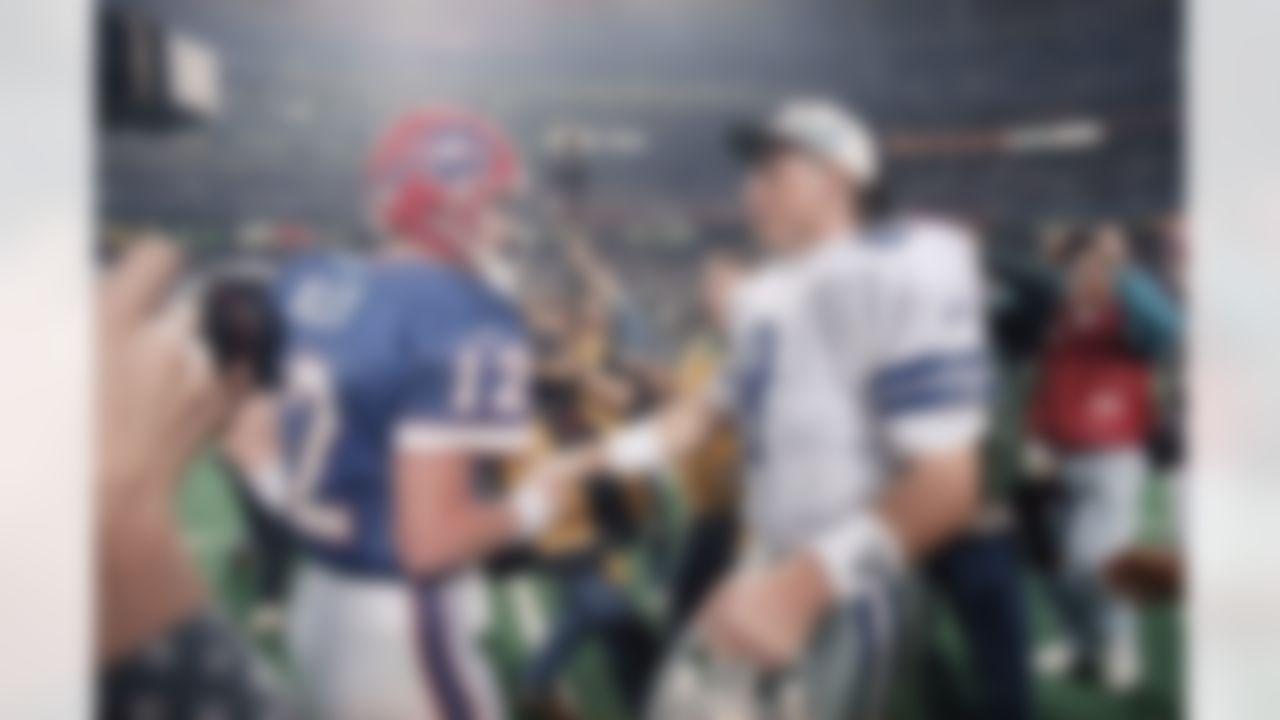 Buffalo Bills quarterback Jim Kelly (12) and Dallas Cowboys quarterback Troy Aikman (8) shake hands after the Cowboys downed the Bills 30-13 in Super Bowl XXVIII at the Georgia Dome in Atlanta, Sunday, Jan. 30, 1994. The win gave the Cowboys back-to-back Super Bowl rings and the loss was a record fourth straight for the Bills. (AP Photo/Doug Mills)
