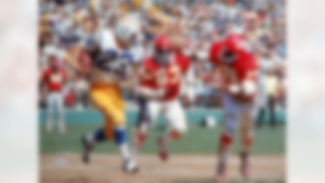 Running back Mike Montgomery #23 of the San Diego Chargers runs upfield as linebackers Willie Lanier #63 and Bobby Bell #78 of the Kansas City Chiefs run in pursuit at San Diego Stadium on September 19, 1971 in San Diego, California. The Chargers defeated the Chiefs 21-14. (National Football League)